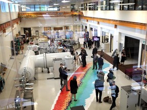 Visitors mingle alongside Canada's only accelerator mass spectrometer, an instrument that measures trace radionuclides, at the University of Ottawa's Advanced Research Complex, which officially opened on Tuesday.