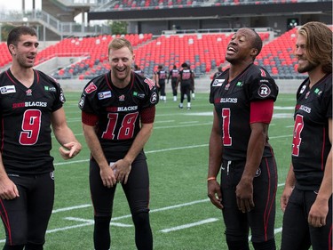 Quarterbacks Danny O'Brien (from left), Joey Elliott, Henry Burris and Alex Carder have a light moment as the Ottawa Redblacks had their official team photos taken at TD Place.