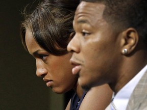 FILE - In this May 23, 2014, file photo, Janay Rice, left, looks on as her husband, Baltimore Ravens running back Ray Rice, speaks to the media during a news conference in Owings Mills, Md. A new video that appears to show Ray Rice striking then-fiance Janay Palmer in an elevator last February has been released on a website.