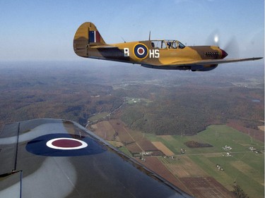 Rob Erdos flies the P40-N Kittyhawk to escort the Canadian Warplane Heritage Museum's Avro Lancaster to Vintage Wings of Canada in Gatineau, Sept. 27, 2014.
