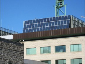 Solar panels are seen on top of Ottawa City Hall.