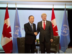Prime Minister Stephen Harper, right, shakes hands with United Nations Secretary General Ban Ki-moon as they attend the Maternal, Newborn and Child Health Summit in Toronto on May 29, 2014.
