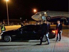 Prime Minister Stephen Harper, right, makes his way to his car as he arrives in London, England, on Tuesday, September 2, 2014. He was greeted by Gordon Campbell, High Commissioner of Canada to the United Kingdom.