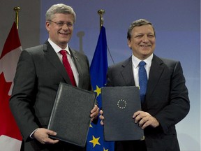 Canadian Prime Minister Stephen Harper stands with European Commission President Jose Manuel Barroso after signing documents Friday, October 18, 2013 at the European Commission in Brussels, Belgium.