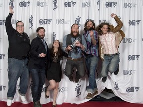 Members of the band Strumbellas celebrate their Juno Award for Roots and Traditional Album of the Year during the Juno Gala in Winnipeg on Saturday, March 29, 2014.
