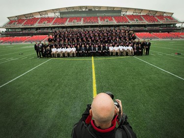 Team photographer F. Scott Grant lines up the players as the Ottawa Redblacks had their official team photo taken at TD Place.