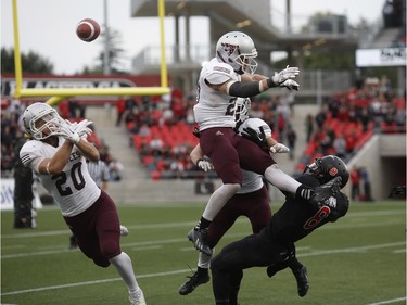 The ball is tipped in a failed interception, landing into the hands of the Carleton Ravens' Nathaniel Behar (not pictured) for a touchdown with no time left to overtake the University of Ottawa Gee-Gees to win the annual Panda Game at TD Place on Sept. 20, 2014.