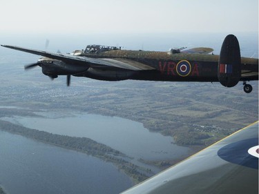 The Canadian Warplane Museum's Avro Lancaster bomber is escorted back to Vintage Wings of Canada at the Gatineau Airport, Sept. 27, 2014. The plane was escorted by Michael Potter, flying a P-51 Mustang, and Rob Erdos, piloting a P-40 Kittyhawk.