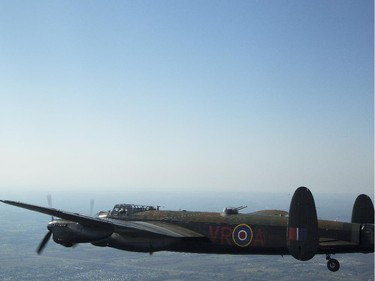 The Canadian Warplane Museum's Avro Lancaster bomber is escorted back to Vintage Wings of Canada at the Gatineau Airport, Sept. 27, 2014. The plane was escorted by Michael Potter, flying a P-51 Mustang, and Rob Erdos, piloting a P-40 Kittyhawk.