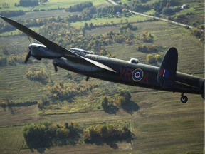 The Canadian Warplane Museum's Avro Lancaster bomber is escorted back to Vintage Wings of Canada at the Gatineau Airport, Sept. 27, 2014. The plane was escorted by Michael Potter, flying a P-51 Mustang, and Rob Erdos, piloting a P-40 Kittyhawk.