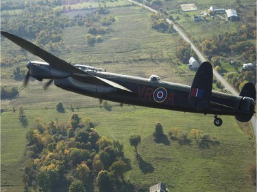 The Canadian Warplane Museum's Avro Lancaster bomber is escorted back to Vintage Wings of Canada at the Gatineau Airport, Sept. 27, 2014. The plane was escorted by Michael Potter, flying a P-51 Mustang, and Rob Erdos, piloting a P-40 Kittyhawk.