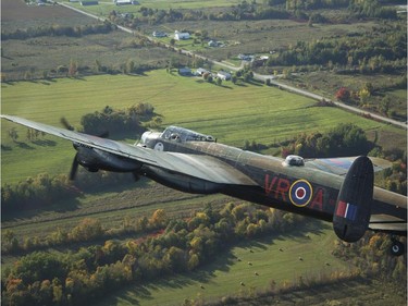 The Canadian Warplane Museum's Avro Lancaster bomber is escorted back to Vintage Wings of Canada at the Gatineau Airport Saturday, September 27, 2014, making a brief stop on its way back from a remarkable summer tour in the U.K. The planes was escorted by Michael Potter flying a P-51 Mustang and Rob Erdos piloting a P-40 Kittyhawk. (Darren Brown/Ottawa Citizen)