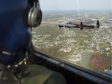The Canadian Warplane Museum's Avro Lancaster bomber is escorted back to Vintage Wings of Canada at the Gatineau Airport, Sept. 27, 2014.