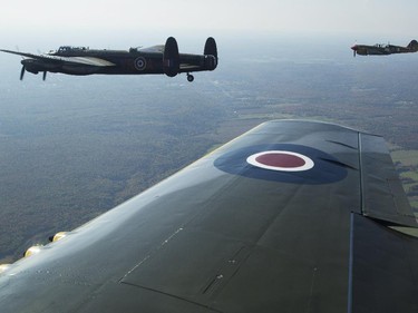 The Canadian Warplane Museum's Avro Lancaster bomber is escorted back to Vintage Wings of Canada at the Gatineau Airport, Sept. 27, 2014. The plane was escorted by Michael Potter, flying a P-51 Mustang, and Rob Erdos, piloting a P-40 Kittyhawk.