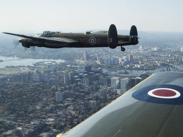 The Canadian Warplane Museum's Avro Lancaster bomber is escorted back to Vintage Wings of Canada at the Gatineau Airport, Sept. 27, 2014. The plane was escorted by Michael Potter, flying a P-51 Mustang, and Rob Erdos, piloting a P-40 Kittyhawk.