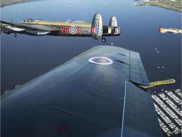 The Canadian Warplane Museum's Avro Lancaster bomber is escorted back to Vintage Wings of Canada at the Gatineau Airport, Sept. 27, 2014. The plane was escorted by Michael Potter, flying a P-51 Mustang, and Rob Erdos, piloting a P-40 Kittyhawk.