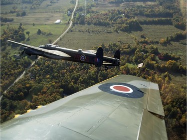 The Canadian Warplane Museum's Avro Lancaster bomber is escorted back to Vintage Wings of Canada at the Gatineau Airport, Sept. 27, 2014. The plane was escorted by Michael Potter, flying a P-51 Mustang, and Rob Erdos, piloting a P-40 Kittyhawk.