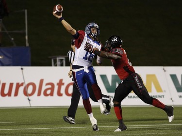 The Montreal Alouettes' Jonathan Crompton throws a pass over the Ottawa Redblacks' Winston Venable in CFL action at TD Place on Sept. 26, 2014.