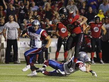 The Ottawa Redblacks' Jonathan Williams evades a tackle for a touchdown in CFL action against the Montreal Alouettes at TD Place on Sept. 26, 2014.