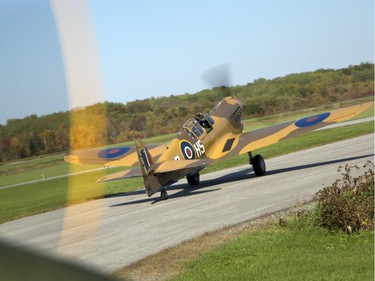 The P40-N Kittyhawk taxi, en route to escort the Canadian Warplane Heritage Museum's Avro Lancaster to Vintage Wings of Canada in Gatineau, Sept. 27, 2014.