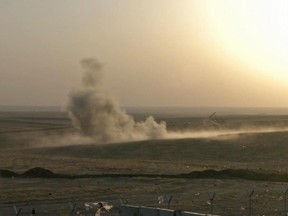 This image made from AP video shows smoke rising from airstrikes targeting Islamic State militants near the Khazer checkpoint outside of the city of Irbil in northern Iraq, Friday, Aug. 8, 2014.