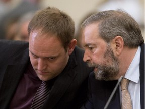 NDP Leader Tom Mulcair speaks with chief of staff Raoul Gebert prior to a committee meeting earlier this year. Gebert was injured in a bike accident this week