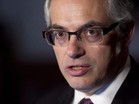 Treasury Board President Tony Clement speaks with the media about negotiations with the public service, Wednesday March 26, 2014 in Ottawa.The Conservative government has touted the thousands of databases it is making public as evidence of its openness and transparency.