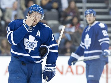 Toronto Maple Leafs forward Phil Kessel wipes his face while playing against the Ottawa Senators during second period pre-season NHL hockey action in Toronto on Wednesday, September 24, 2014.