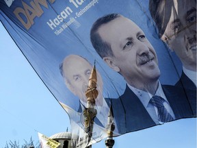 A picture showing Turkish prime minister Recep Tayyip Erdogan (C) and Istanbul mayor Kadir Topbas (L) and the minarets of a mosque is pictured in Istanbul on March 21, 2014. Turkey's combative prime minister warned March 21, 2014 that he would eradicate Twitter.