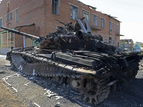 A destroyed tank sits in the courtyard of the local kindergarten in the village of Talakovka, some 22 kilometres northeast of Mariupol, on September 6, 2014, a day after Kiev and pro-Russian rebels signed a ceasefire after five months conflict which has plunged relations between Russia and the West into their worst crisis since the Cold War.