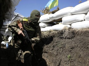A Ukrainian soldier moves along a trench at their position close to the small eastern Ukrainian city of Pervomaysk, in Lugansk region on September 13, 2014. Russia has delivered a second shipment of aid to rebel-controlled Ukraine, sending trucks carrying 2,000 tonnes of goods unaccompanied across the border, national television said.