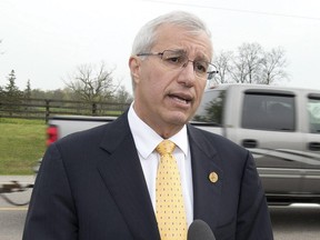 Ontario PC candidate Vic Fedeli speaks beside a highway outside a campaign event for Ontario Premier Kathleen Wynne in Paris, Ontario on Tuesday May 20, 2014, 2014.