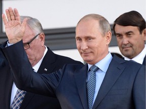 Russian President Vladimir Putin waves to people in the city of Gorno-Altaisk, Siberia, Russia on Thursday, Sept. 4, 2014.