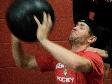 Zack Smith grimaces while throwing the medicine ball as the Ottawa Senators are given medicals and tested for strength and conditioning.