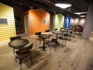 The cafe is inspired by east coast architecture in the new Shopify offices at 150 Elgin St. in Ottawa Friday, October 17, 2014. Each coloured cabin-like structure is a work-space where employees can meet in private or work. (Darren Brown/Ottawa Citizen)