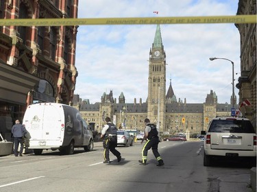 Police secure the scene of a shooting on Parliament Hill in Ottawa on Wednesday Oct.22, 2014. A Canadian soldier standing guard at the National War Memorial in Ottawa has been shot by an unknown gunman and there are reports of gunfire inside the halls of Parliament.