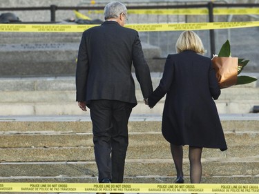 Prime Minister Stephen Harper and Laureen Harper paid their respects and laid flowers Oct 23 at the Cenotaph where a soldier was shot dead Oct 22. The gunman was later killed when he stalked the halls of Parliament Hill.