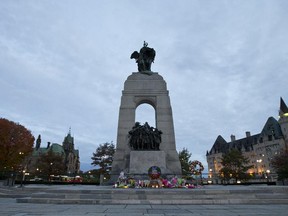 Candles and flowers and Canadian flags adorn the area around the Tomb of the Unknown Soldier Oct 24 at the Cenotaph.