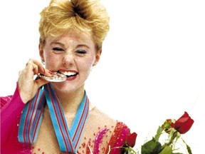 Elizabeth Manley bites the silver medal she won at the Calgary Olympics in 1988.