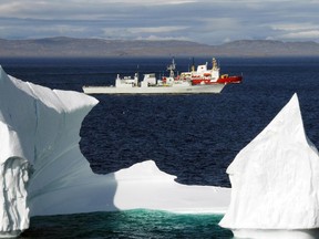 HMCS Toronto and the Canadian Coast Guard Ship (CCGS) Pierre Radisson sail past an iceberg in the Hudson Strait off the coast of Baffin Island. Photo by: Sergeant Kevin MacAulay