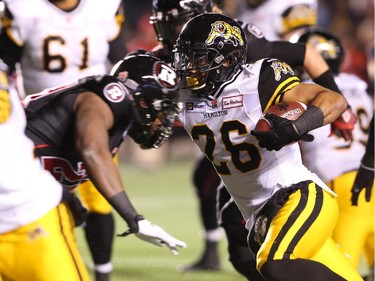 Delvin Breaux of the Hamilton Tiger-Cats runs the ball against the Ottawa Redblacks during first half CFL action.