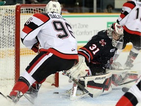 Dante Salituro, left, scores the 67's first goal on Brent Moran in the first period in Ottawa's home opener at the renovated TD Place arena.
