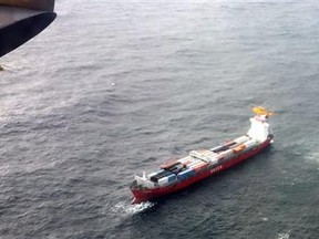 In this aerial photo provided by the Department of National Defense Maritime Forces Pacific, a Canadian Coast Guard helicopter flies near a Russian container ship, carrying hundreds of tons of fuel drifting without power in rough seas off British Columbia's northern coast on Friday, Oct. 17, 2014. The Canadian Forces' joint rescue coordination center in Victoria said the Russian carrier Simushir lost power late Thursday night off Haida Gwaii, also known as the Queen Charlotte Islands, as it was making its way from Washington state to Russia. (AP Photo/The Canadian Press, Department of National Defense Maritime Forces Pacific)