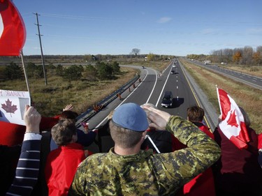 A Canadian Soldier salutes the hearse carrying the body of Cpl. Nathan Cirillo on the Veterans Memorial Highway in Ottawa on Friday, October 24, 2014.