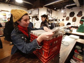 A customer looks through albums at The 4in1 Record Sale at the Antique Skate Shop in Ottawa on Sunday, October 19, 2014.