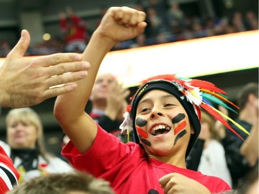 A fan of the Chicago Blackhawks celebrates his team's goal against the Ottawa Senators during third period NHL action.