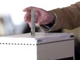 A man casts his vote for the 2011 federal election in Toronto in this May 2, 2011 photo.The trial of the lone junior Conservative campaign worker charged in the robocall scandal is set to begin Monday.Michael Sona, 25, is charged with wilfully preventing or endeavouring to prevent an elector from voting.THE CANADIAN PRESS/Chris Young   // ADD: Canadian federal election ballot box Elections Canada /pws