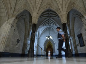 A security guard walks past the Hall of Honour in the Centre Block Thursday.