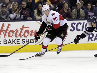 Ottawa Senators' Alex Chiasson, left, looks for an open shot as Columbus Blue Jackets' Ryan Murray defends during the third period.