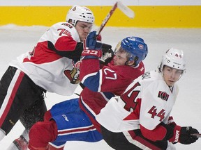 The Canadiens' Alex Galchenyuk collides with the Ottawa Senators' Mark Borowiecki, left, and Jean-Gabriel Pageau during the first period in Montreal on Saturday, October 4, 2014.